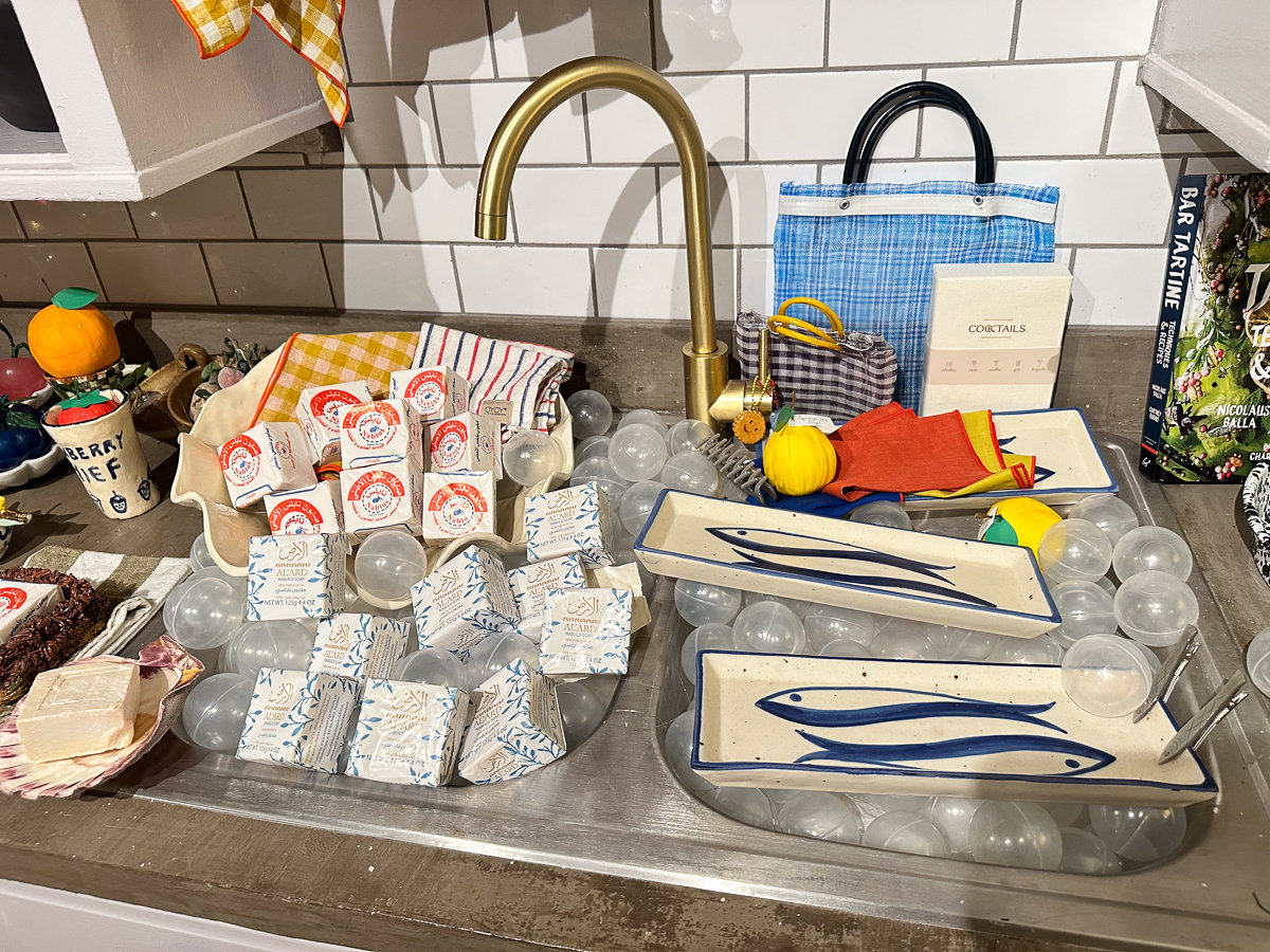 kitchen sink with various soaps and items to buy